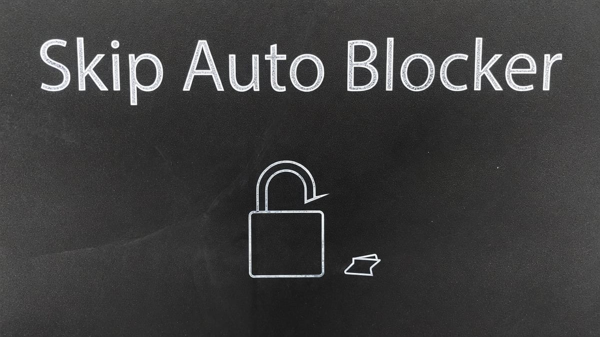 Light chalk padlock slightly open on dark asphalt, a USB switch doodle, and the words skip Auto Blocker